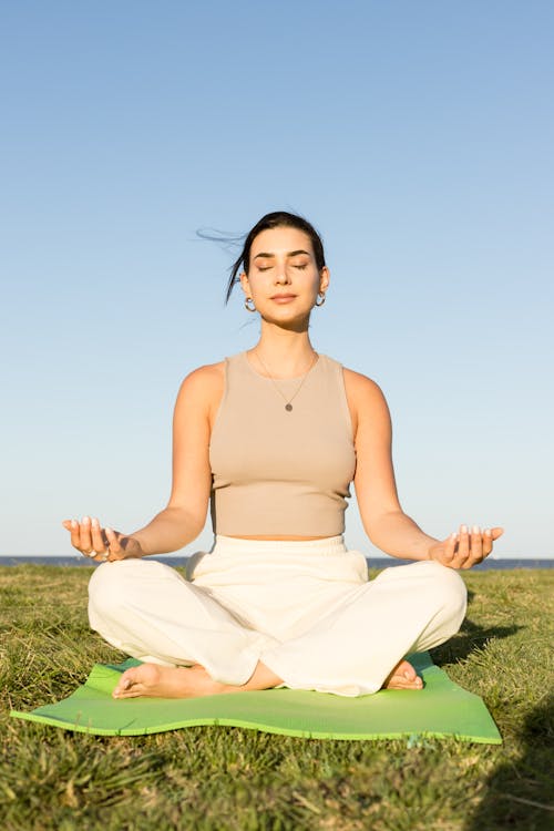 Woman Meditating on Grass