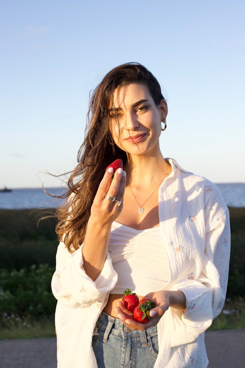 Woman in White Holding Strawberries