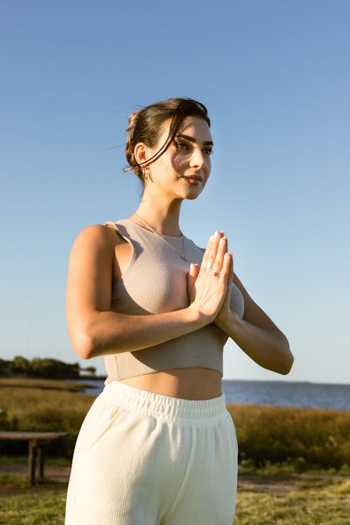 Woman in Yoga Pose with Clasped Hands