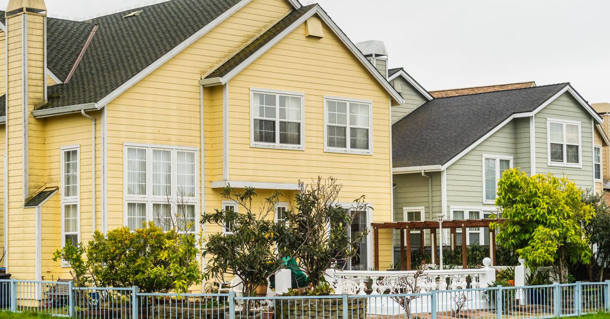 Bright suburban houses with gardens and fences, perfect for family living.