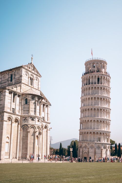 Free Iconic Leaning Tower of Pisa and cathedral under clear skies in Pisa, Italy. Stock Photo