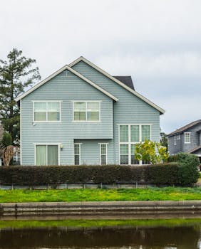A contemporary detached house in a suburban neighborhood with a scenic canal front.