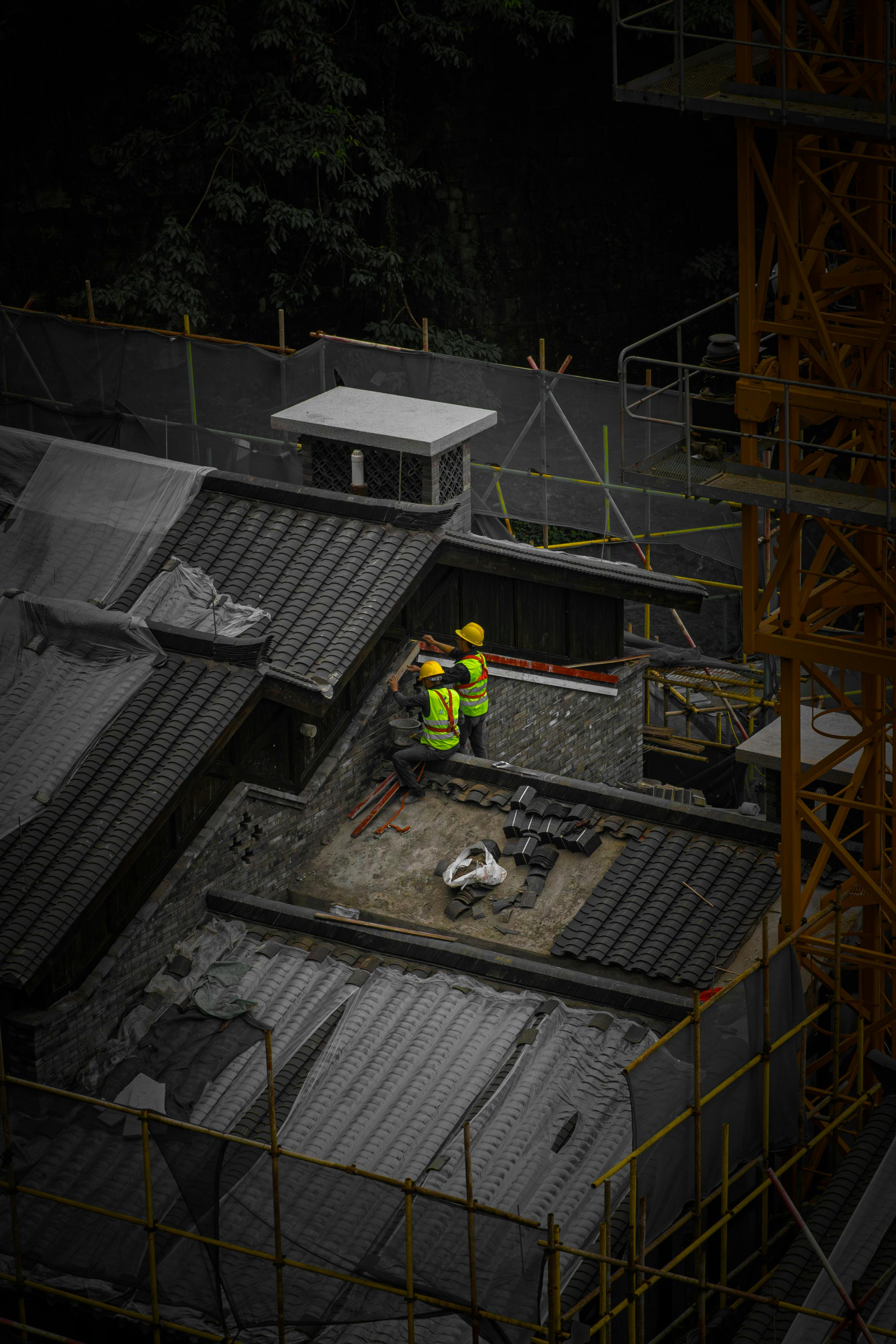 Two Construction Workers on a Rooftop · Free Stock Photo