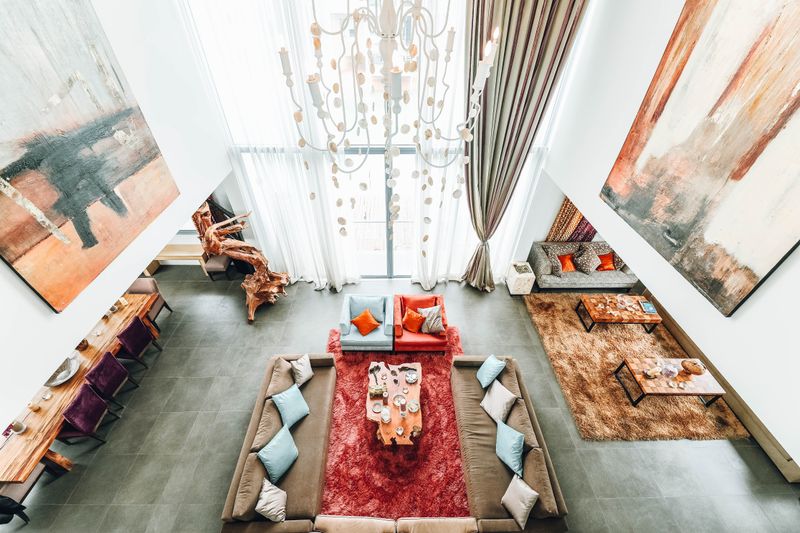 Bright living room with dining area finished in large-format marble tiles