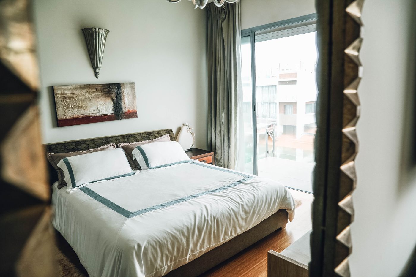 luxury bedroom with floor-to-ceiling windows and city view — real estate photography Paris | ProShoot.io