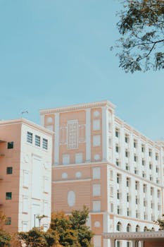 A contemporary office building's facade amidst a clear blue sky in Mysore, perfect for urban and architectural themes.