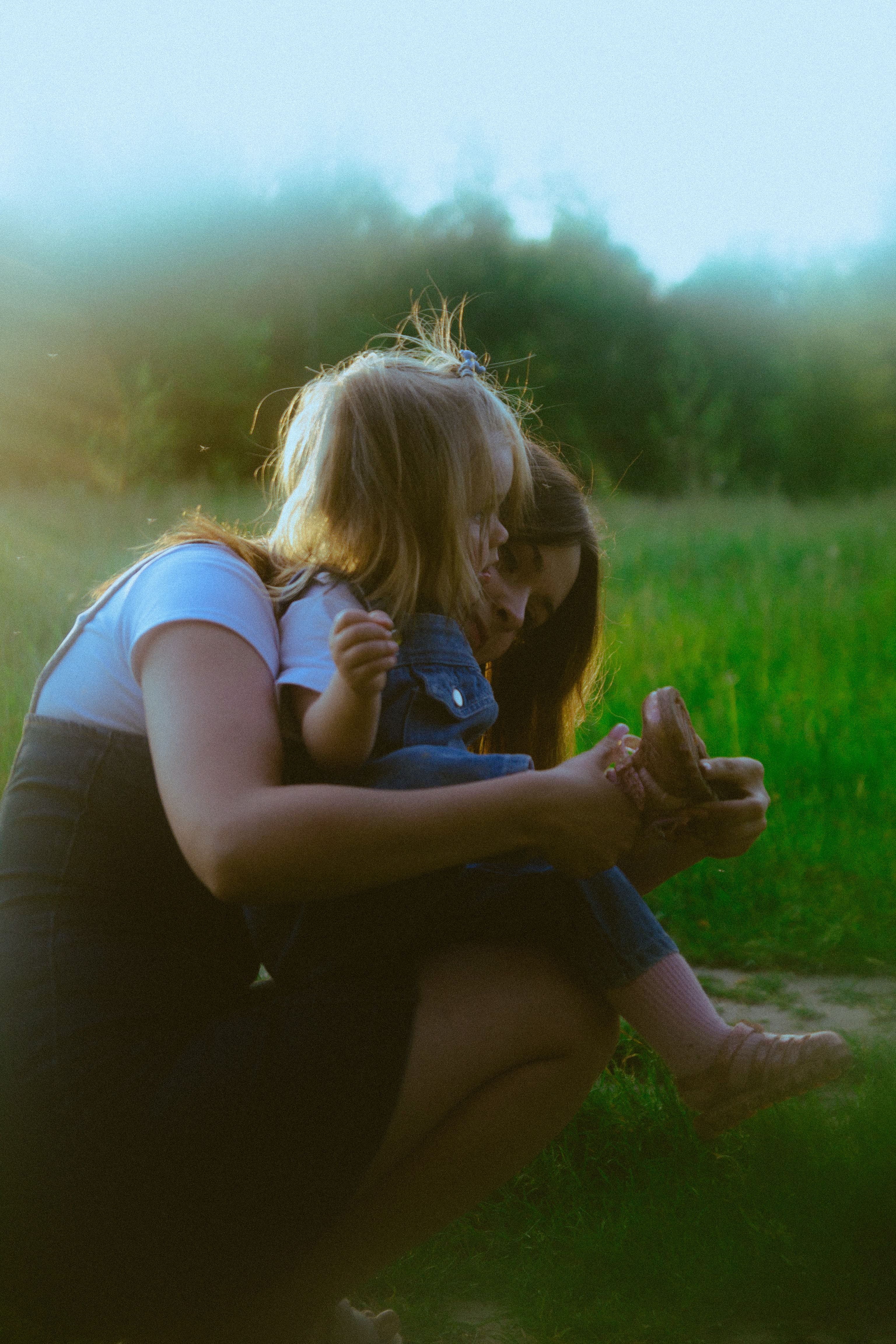 Two Young Women Sitting on a Park Bench · Free Stock Photo