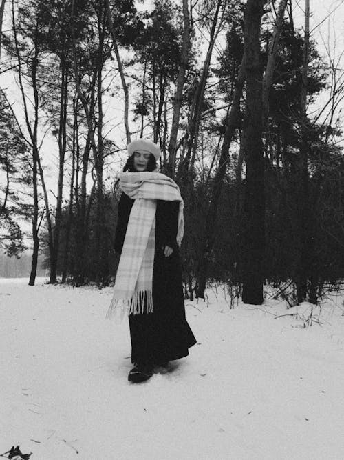 Woman in Hat and Scarf in Forest in Winter