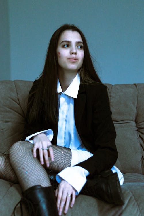 Woman in Black Suit Jacket Sitting on Couch