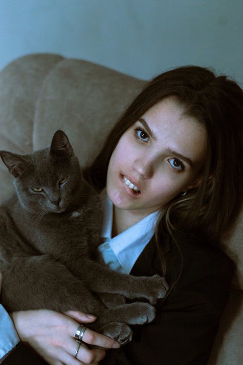 Woman with Black Hair Holding Cat