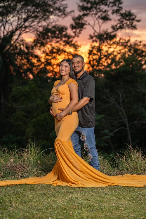 Smiling Man and Pregnant Woman in Yellow Dress