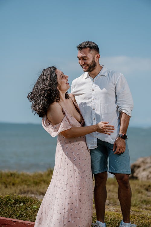 Smiling Woman in Dress and Man in Shirt