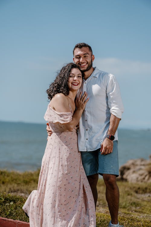 A Smiling Couple Hugging on a Beach 