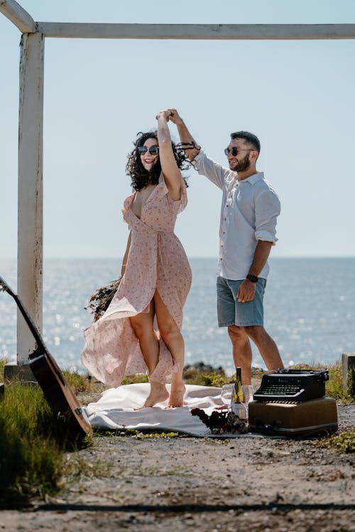 Smiling Couple Standing on Picnic on Sea Coast