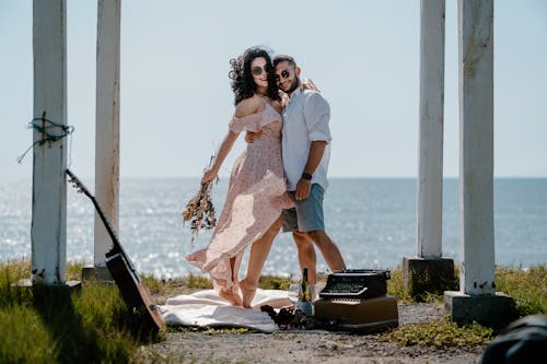 A Happy Couple Embracing on a Shore 