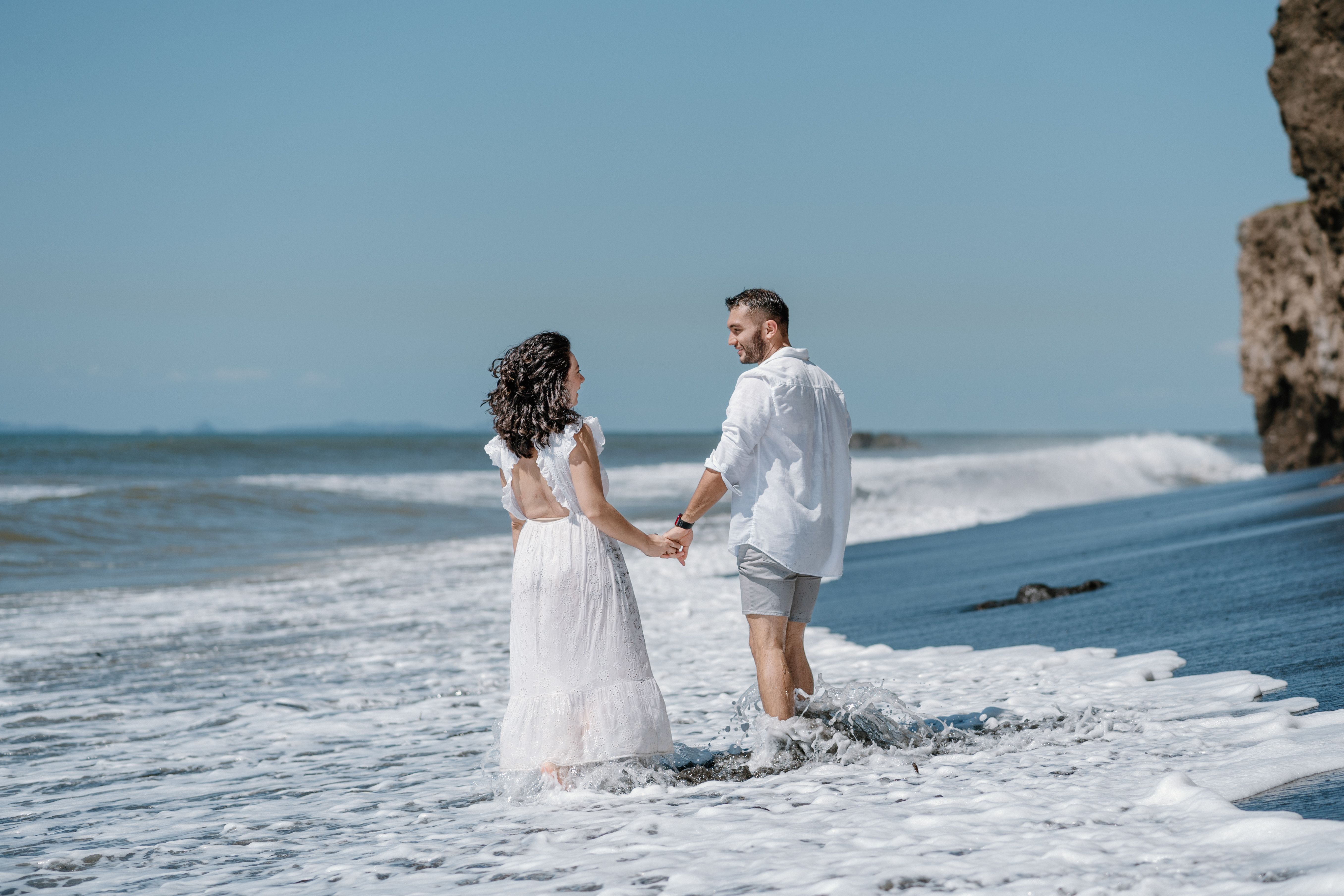 Couple Holding Hands on Sea Shore · Free Stock Photo