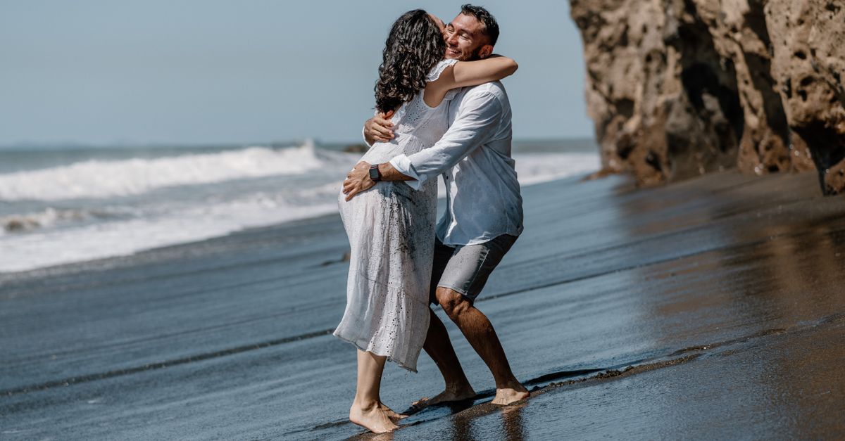 Seeman Hugging Man Hugging Woman on Sea Shore · Free Stock Photo