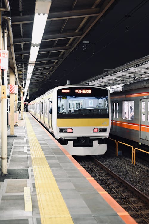 A train is pulling into a station at night