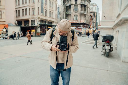 A photographer captures the hustle and bustle of a city street with a medium format camera.