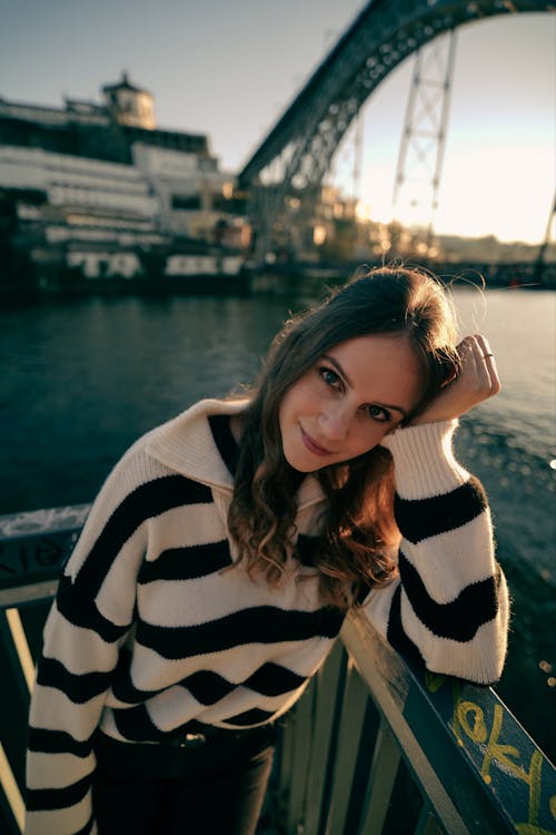 Free Portrait of a Pretty Brunette Wearing a Striped Sweater Stock Photo