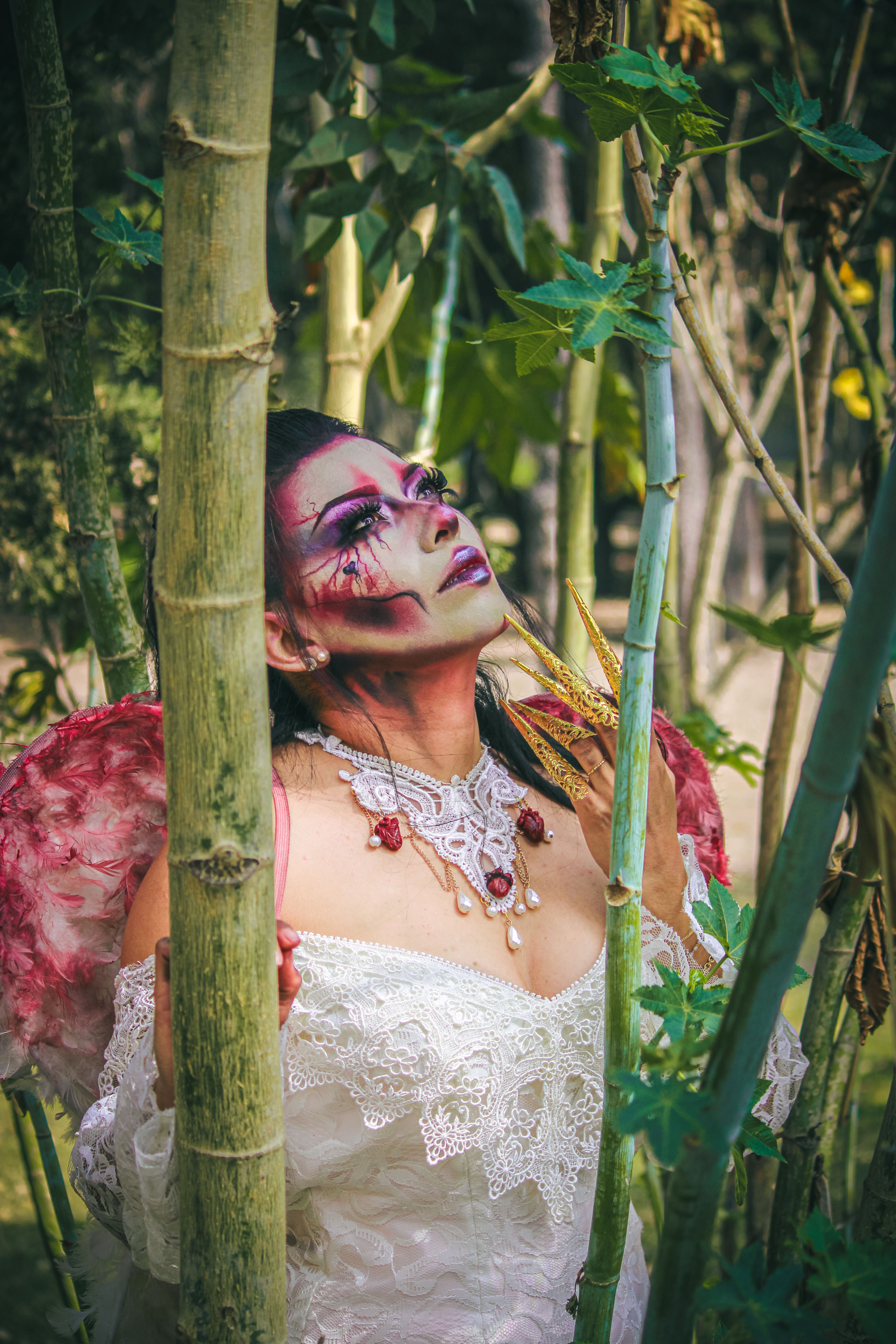 Woman in Cosplay Dress Standing among Bamboo Trees · Free Stock Photo