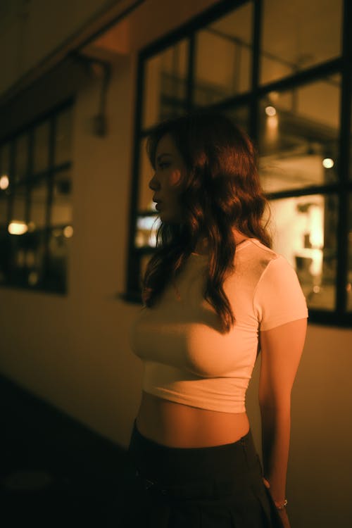 Woman in White Top at Night