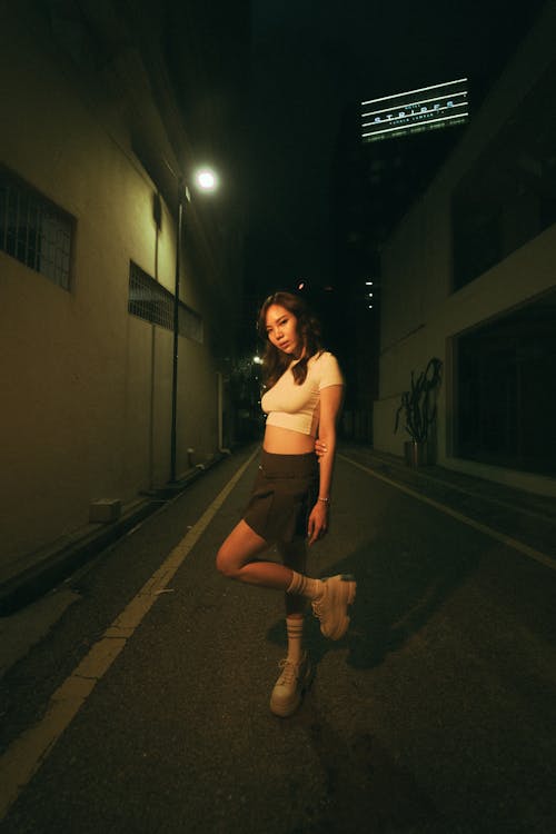 Brunette Woman in a Narrow Alley at Night 