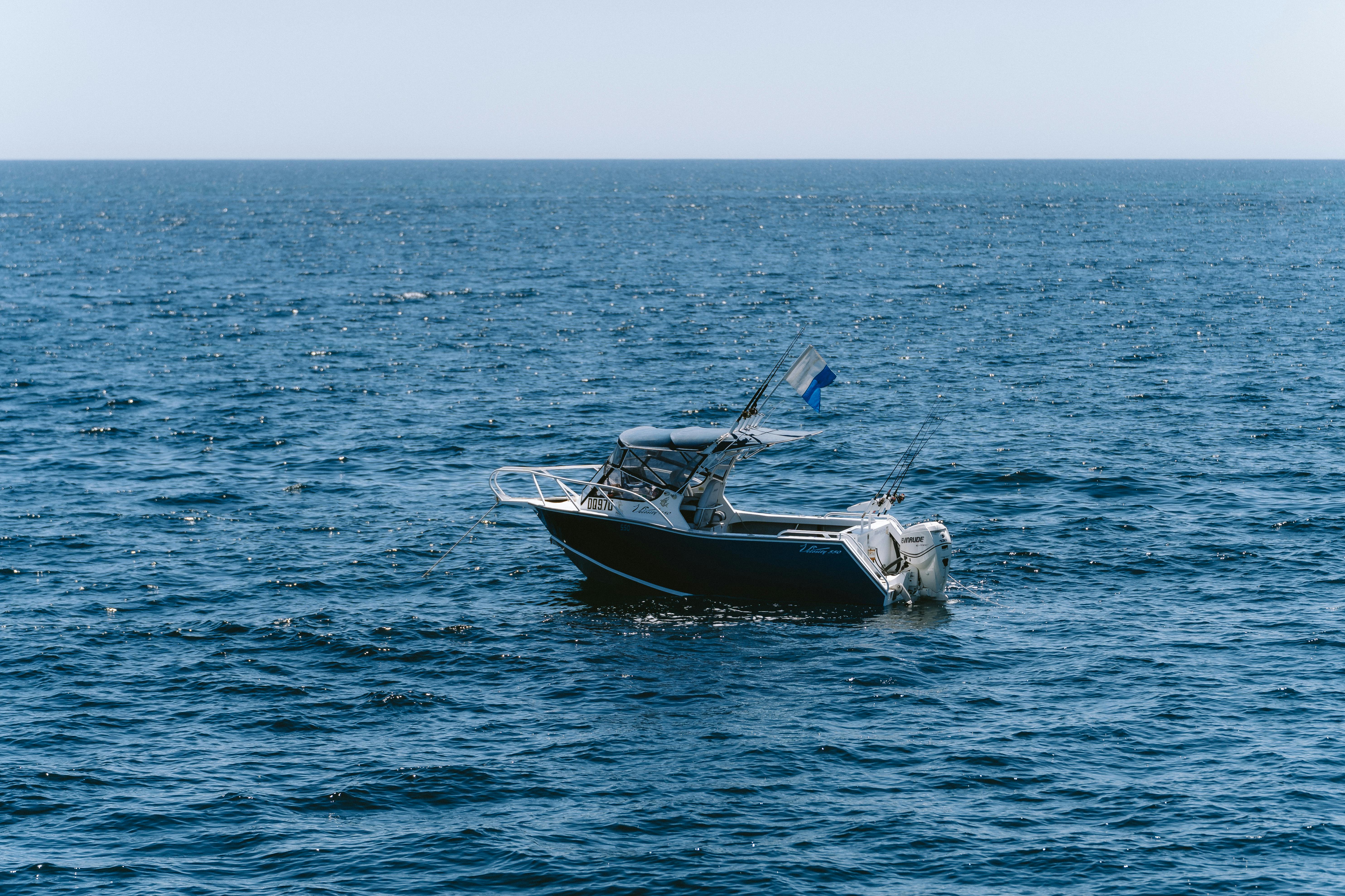 Aluminium motorboat floating on clear Australian coastal water