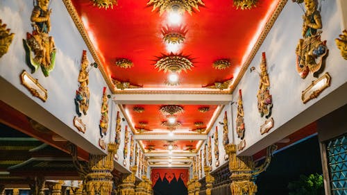 The ceiling of a temple with gold and red decorations