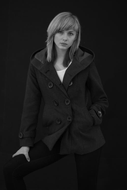 Black and white photo of a woman in a coat