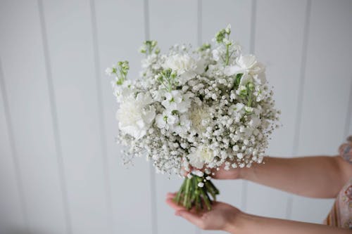 Woman Holding Bouquet of White Flowers