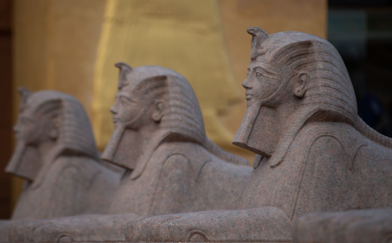 close up of stone sphinx statues in ancient egyptian style highlightin
