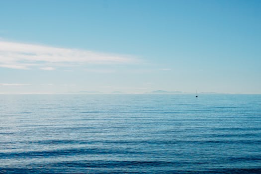 Peaceful ocean view with a lone boat on the horizon in Marbella, Spain.