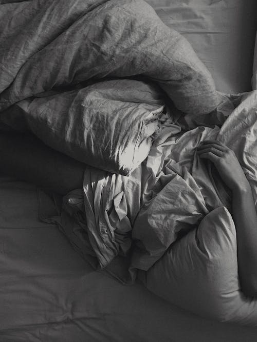 Person Lying on Bed Covering White Blanket · Free Stock Photo