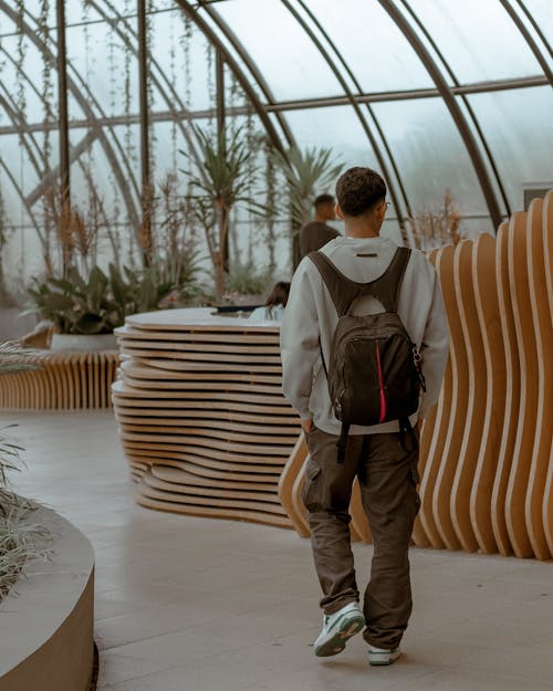 Man with Backpack Walking between Walls