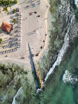 Discover the stunning aerial view of Playa del Carmen's beachfront with turquoise waters and white sands.