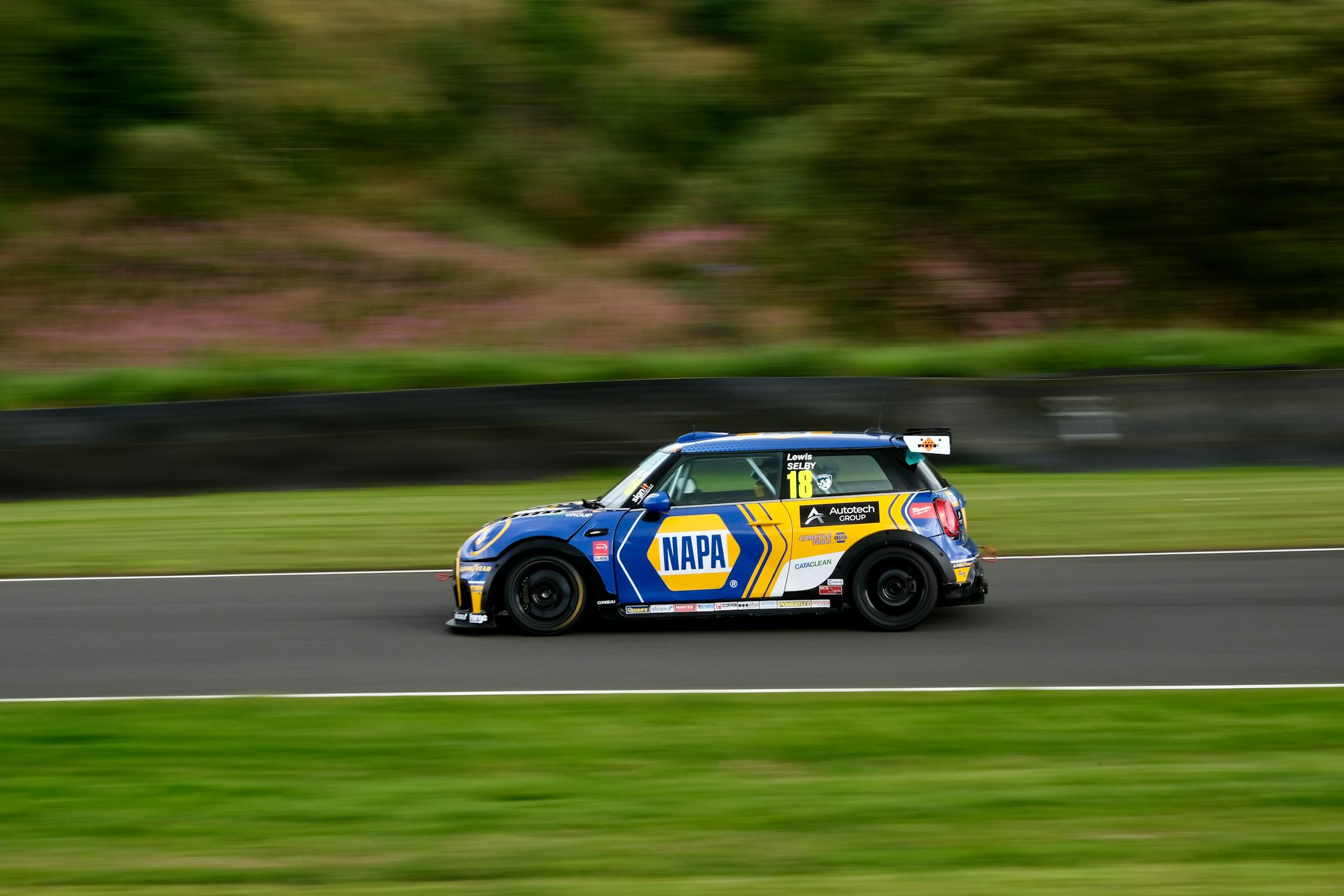 Racing Mini Cooper Speeding Around the Track · Free Stock Photo