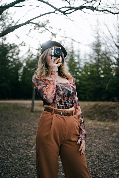 Blonde Woman in Beret Standing with Camera