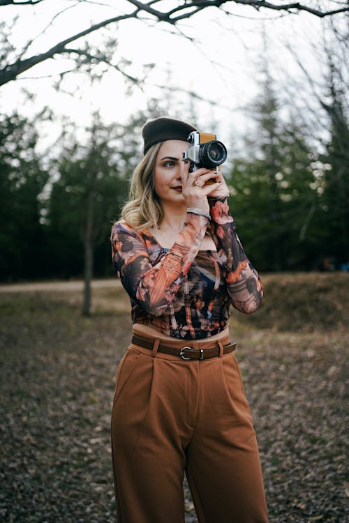 Blonde Woman in Beret Taking Pictures with Camera
