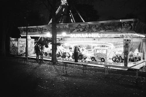A black and white photo of a carnival ride