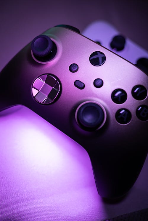 A purple light shines on a video game controller