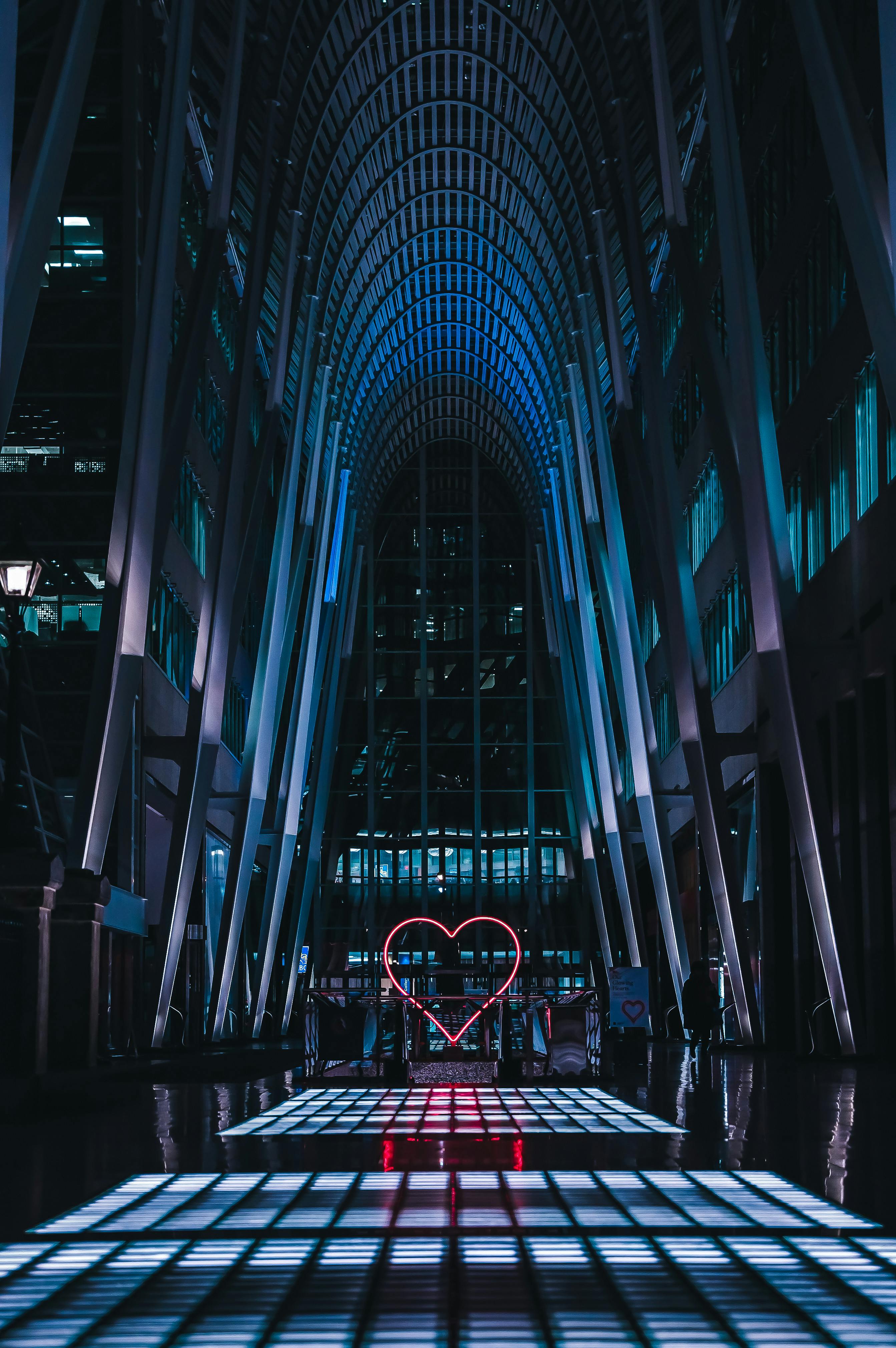 Captivating view of a modern interior in Toronto with a neon heart installation and blue lighting.