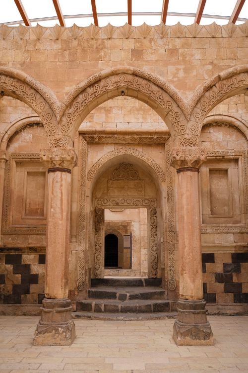 Free Explore the intricate stone arches within Ishak Pasha Palace in Turkey, a masterpiece of Ottoman architecture. Stock Photo
