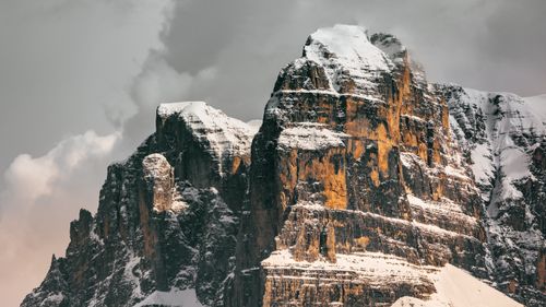 Free Majestic snow-capped mountain peaks under gray winter skies, showcasing natural beauty and rugged terrain. Stock Photo