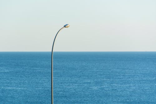 A street light is next to the ocean
