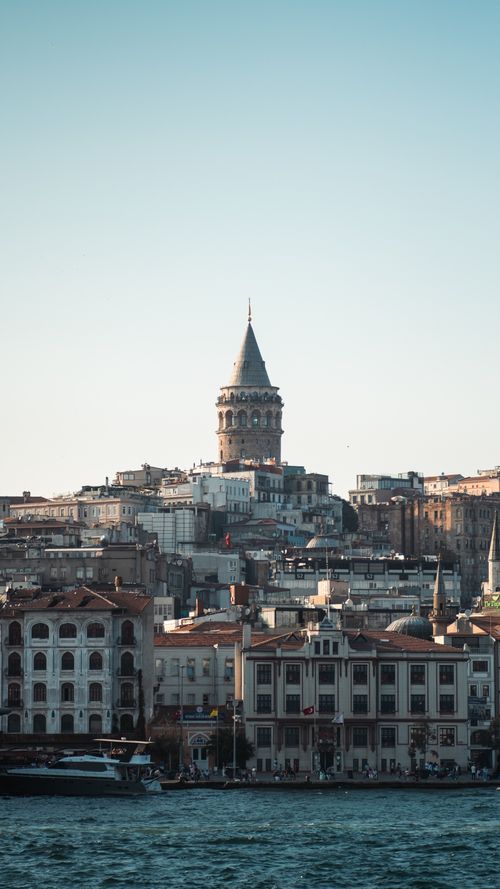 Free Galata Tower rises above Istanbul's skyline, showcasing Ottoman architecture by the sea. Stock Photo