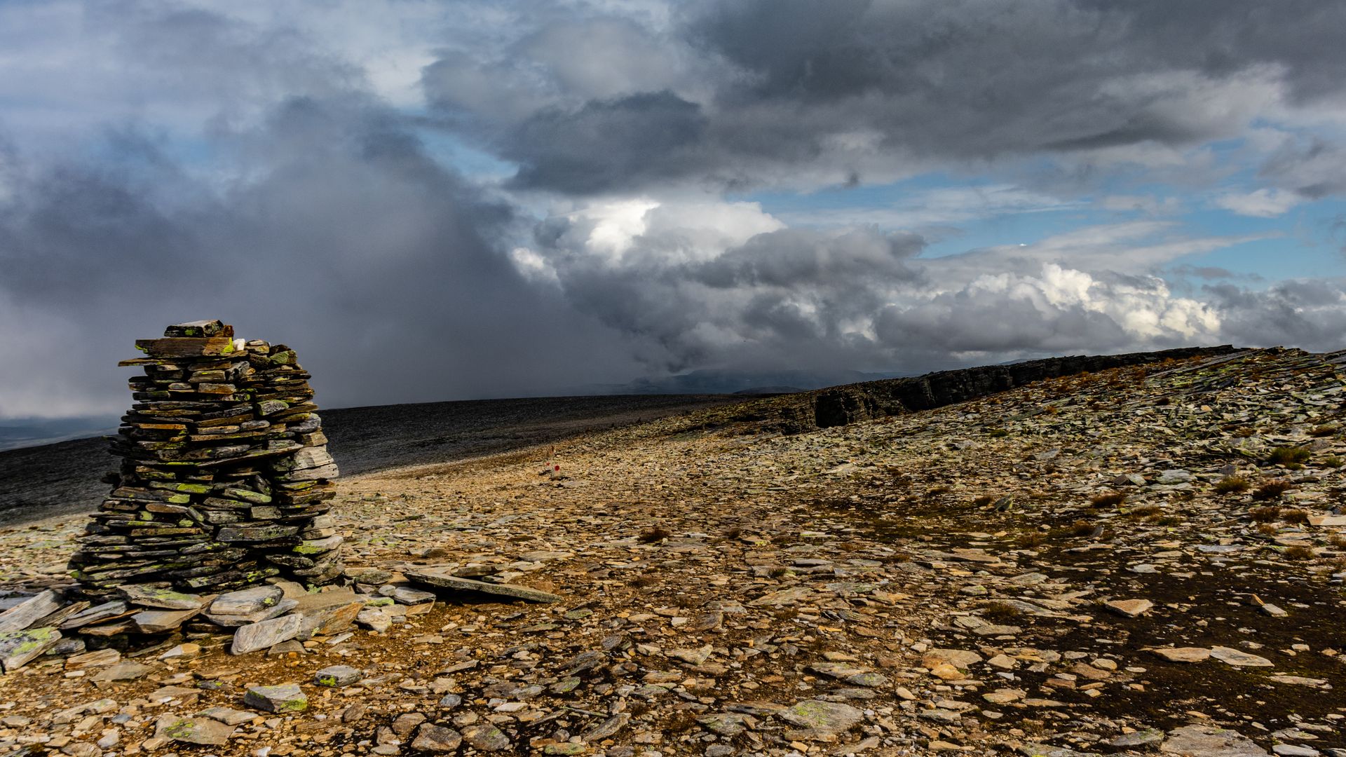 Clouds over Hill with Heap of Stones