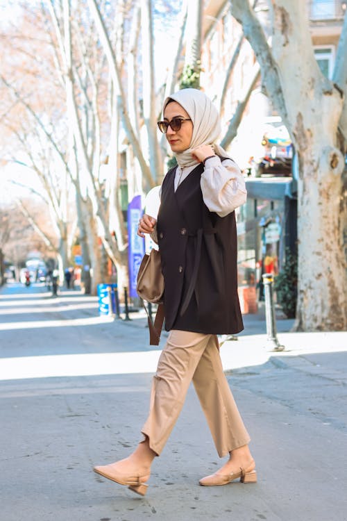 A woman in a hijab walking down the street