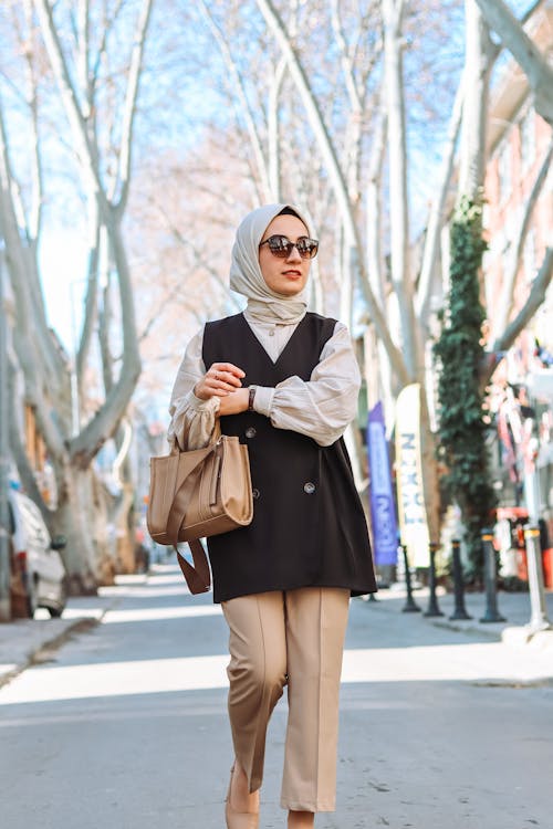A woman in a hijab walking down the street