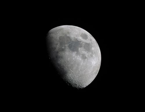 Free A detailed, high-resolution photograph of the moon's craters and surface features against a black sky. Stock Photo